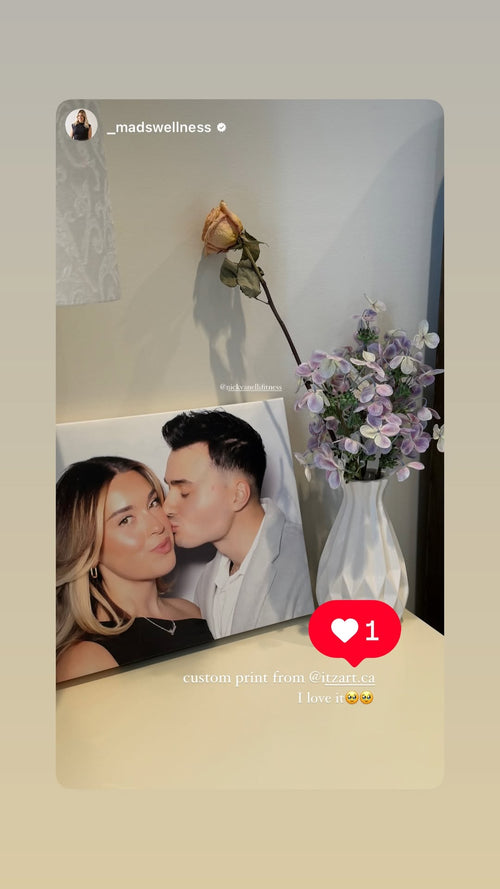 Custom photo print of a man kissing a woman’s cheek, displayed beside flowers, with the customer’s caption “I love it.”