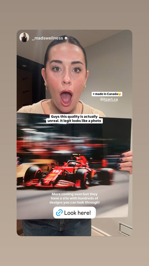 Customer holding a red Ferrari Formula 1 art print, with a review saying the quality looks like a photo