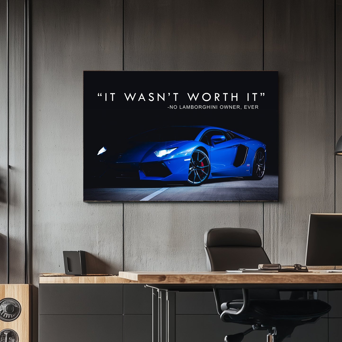 A sleek metal print of a blue Lamborghini photographed at night with illuminated headlights, accompanied by the text "It wasn’t worth it – no Lamborghini owner, ever."