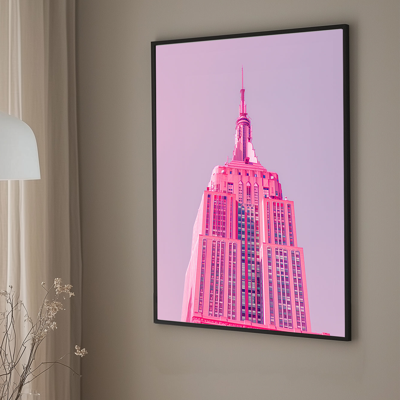 A pink wall art print of the Empire State Building in soft pink tones against a pastel background, showcasing minimalistic modern architecture.