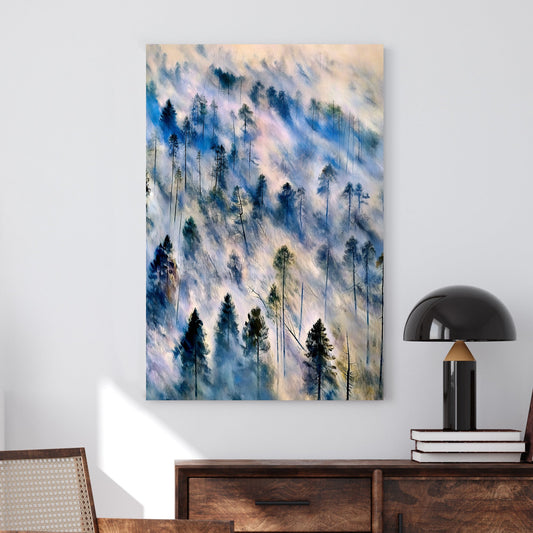 Ethereal landscape wall art of mist-covered pine trees in soft blue, grey, and earth tones, evoking a tranquil forest scene.