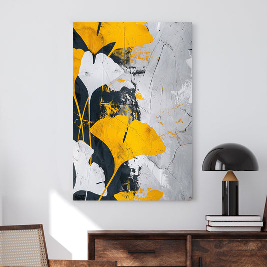 Abstract wall art of golden-yellow ginkgo leaves against a black, white, and grey textured background.