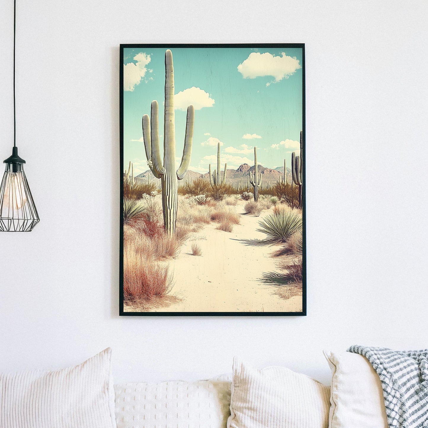 Vintage-style desert landscape featuring towering saguaro cacti, golden sand, and distant mountains under a pale blue sky.