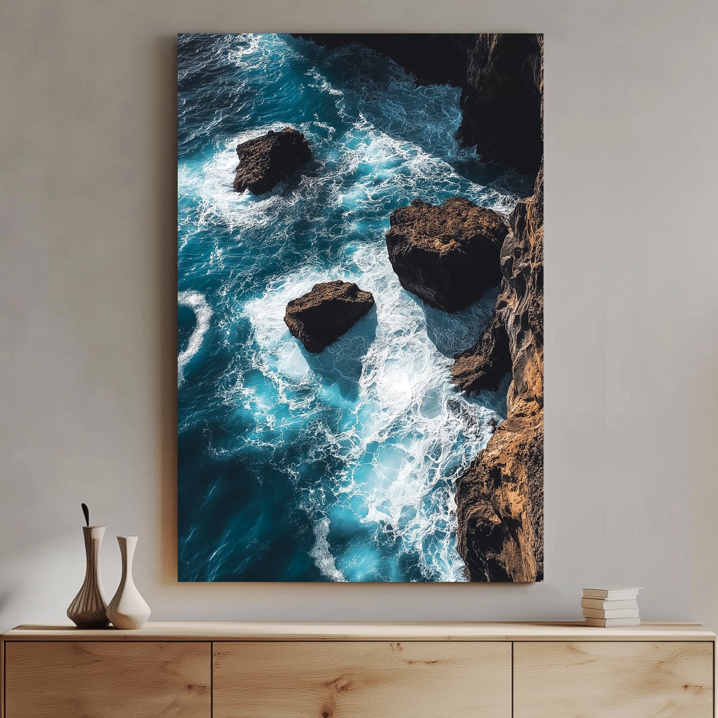 Dramatic ocean wall art featuring waves crashing against rocky cliffs in deep blue tones.