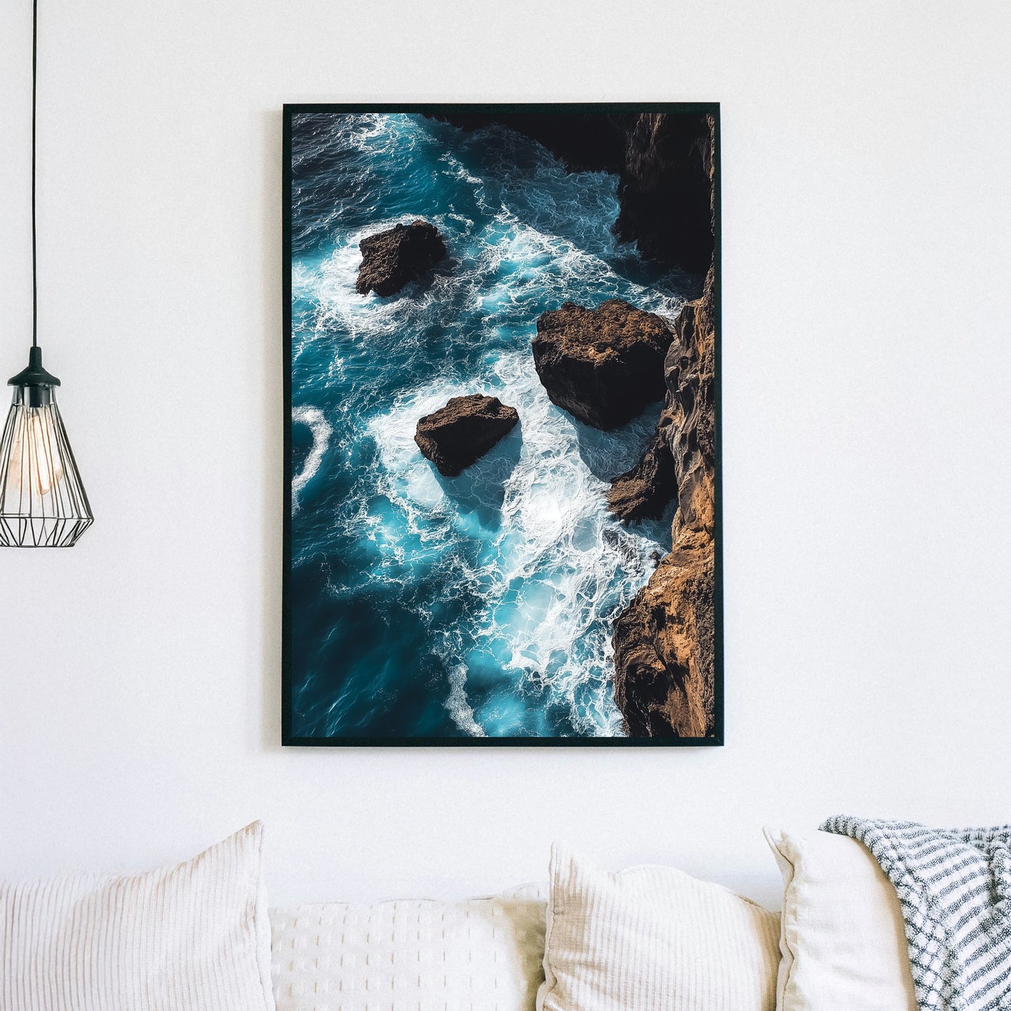 Dramatic ocean wall art featuring waves crashing against rocky cliffs in deep blue tones.