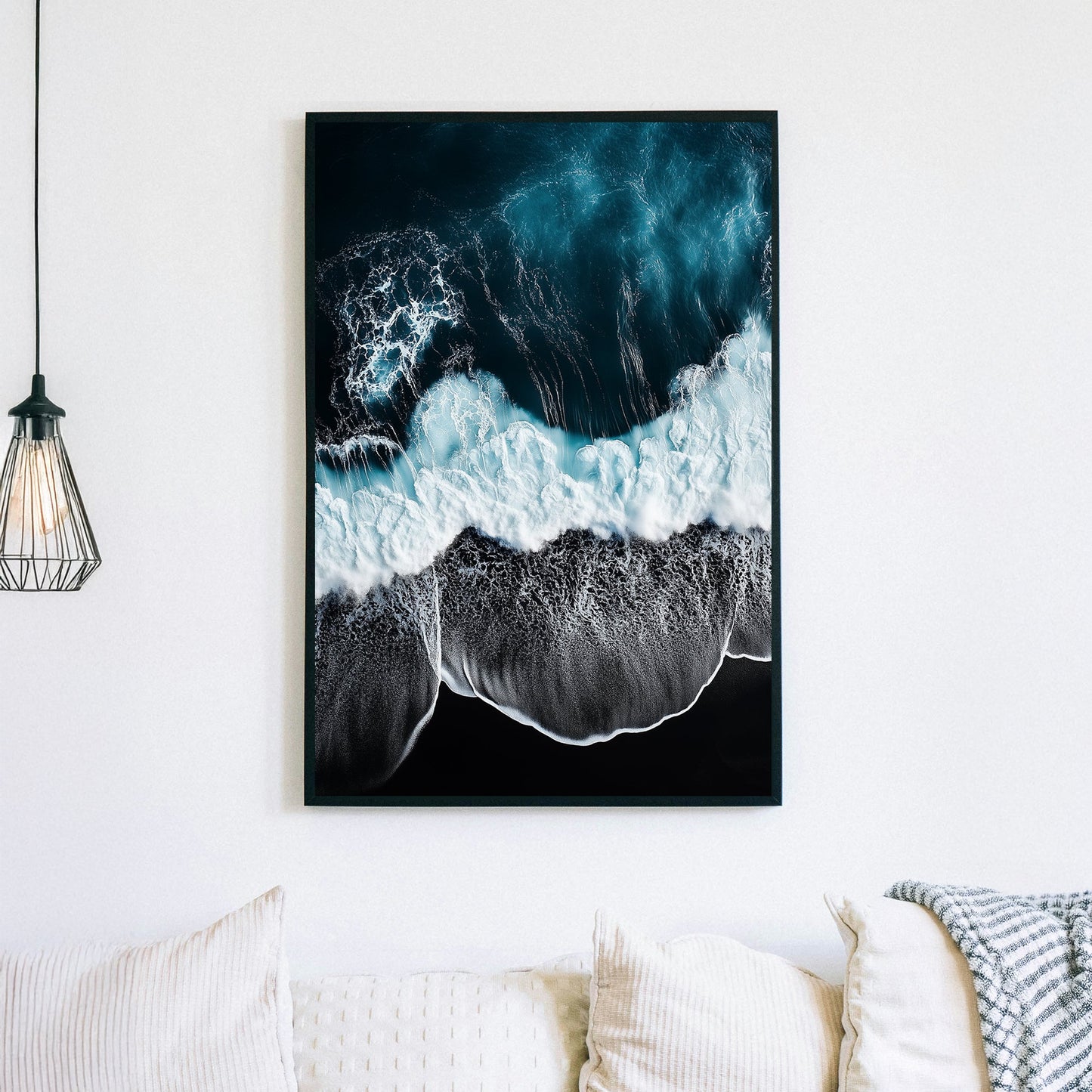 Aerial ocean wall art with deep blue waves crashing onto a black sand beach.