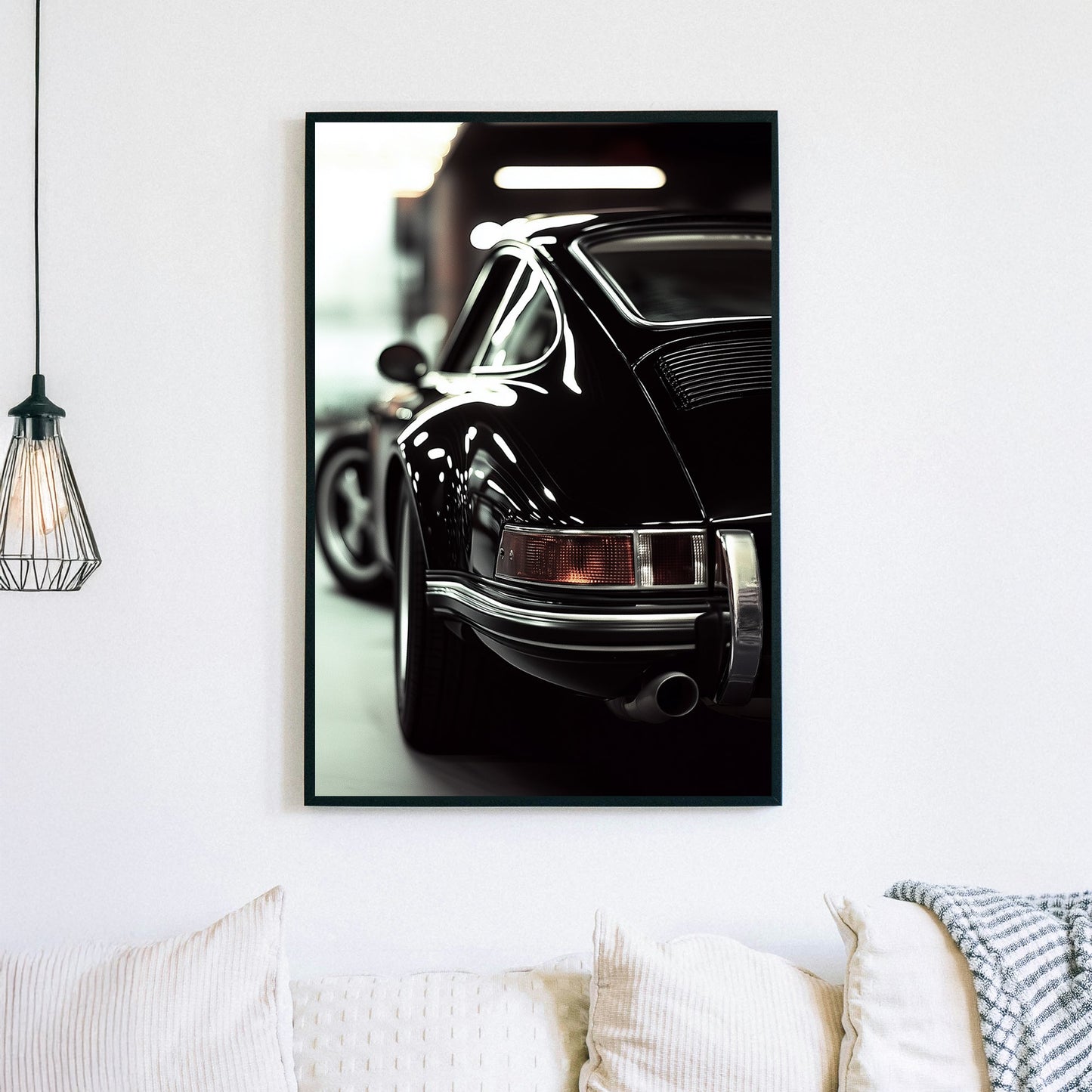 Close-up of a classic black Porsche with reflective chrome details in a dimly lit garage.