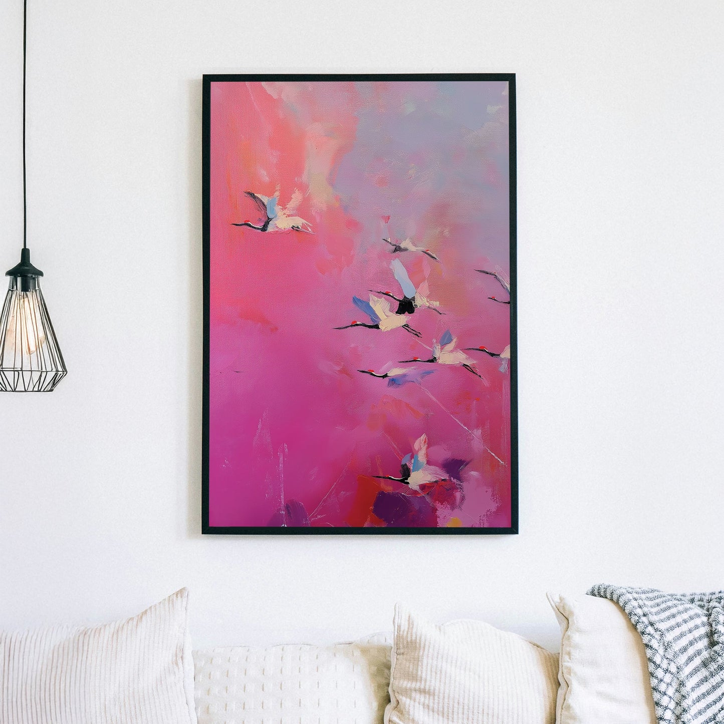 Pink and purple wall art of flying cranes in a dreamy sky