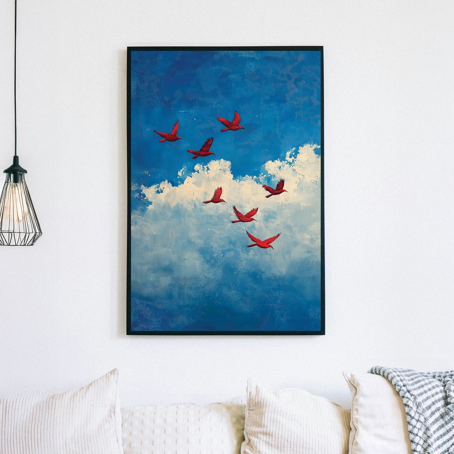 Wall art of red birds flying across a blue sky with textured white clouds