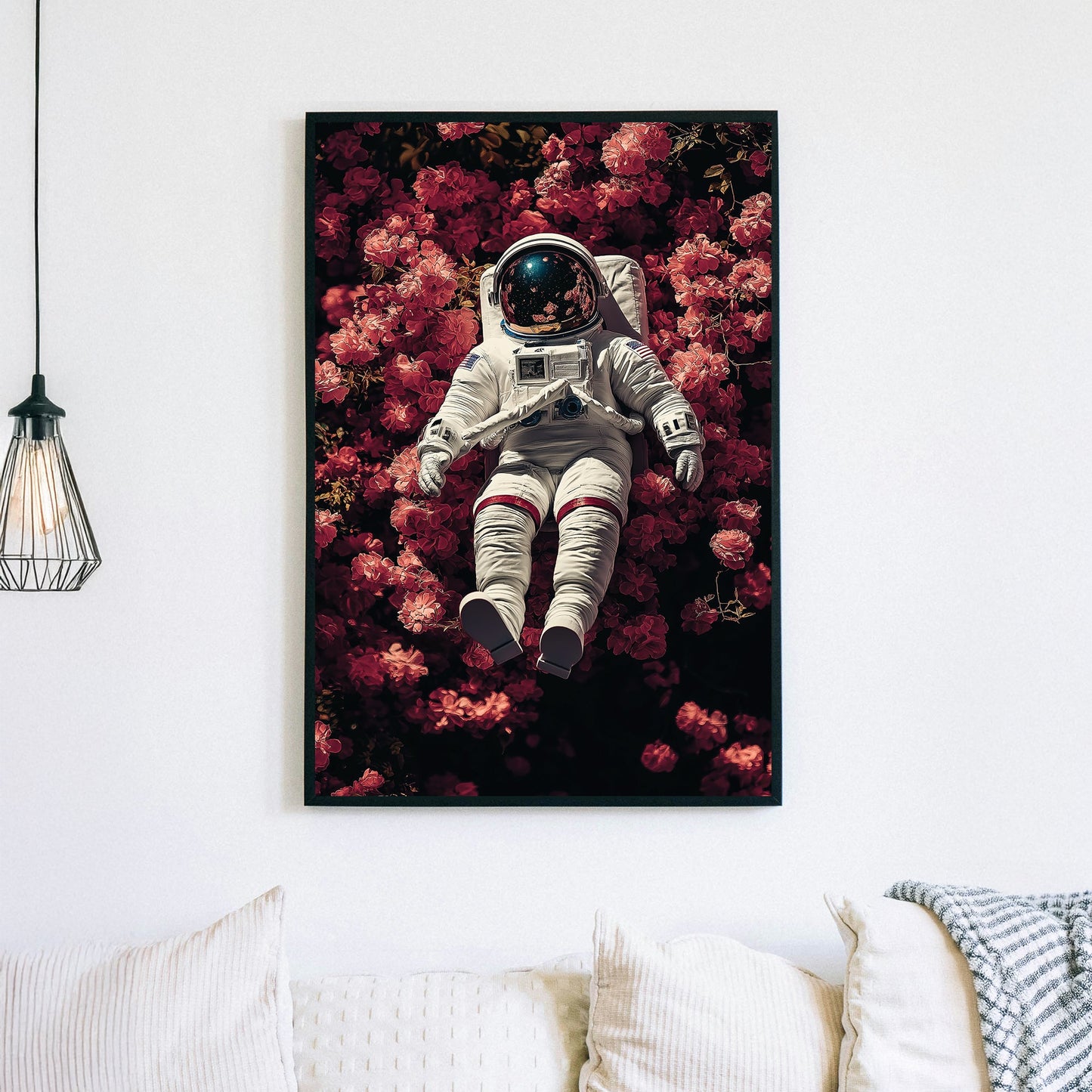 wall art of astronaut resting in a field of pink flowers with galaxy reflection in helmet