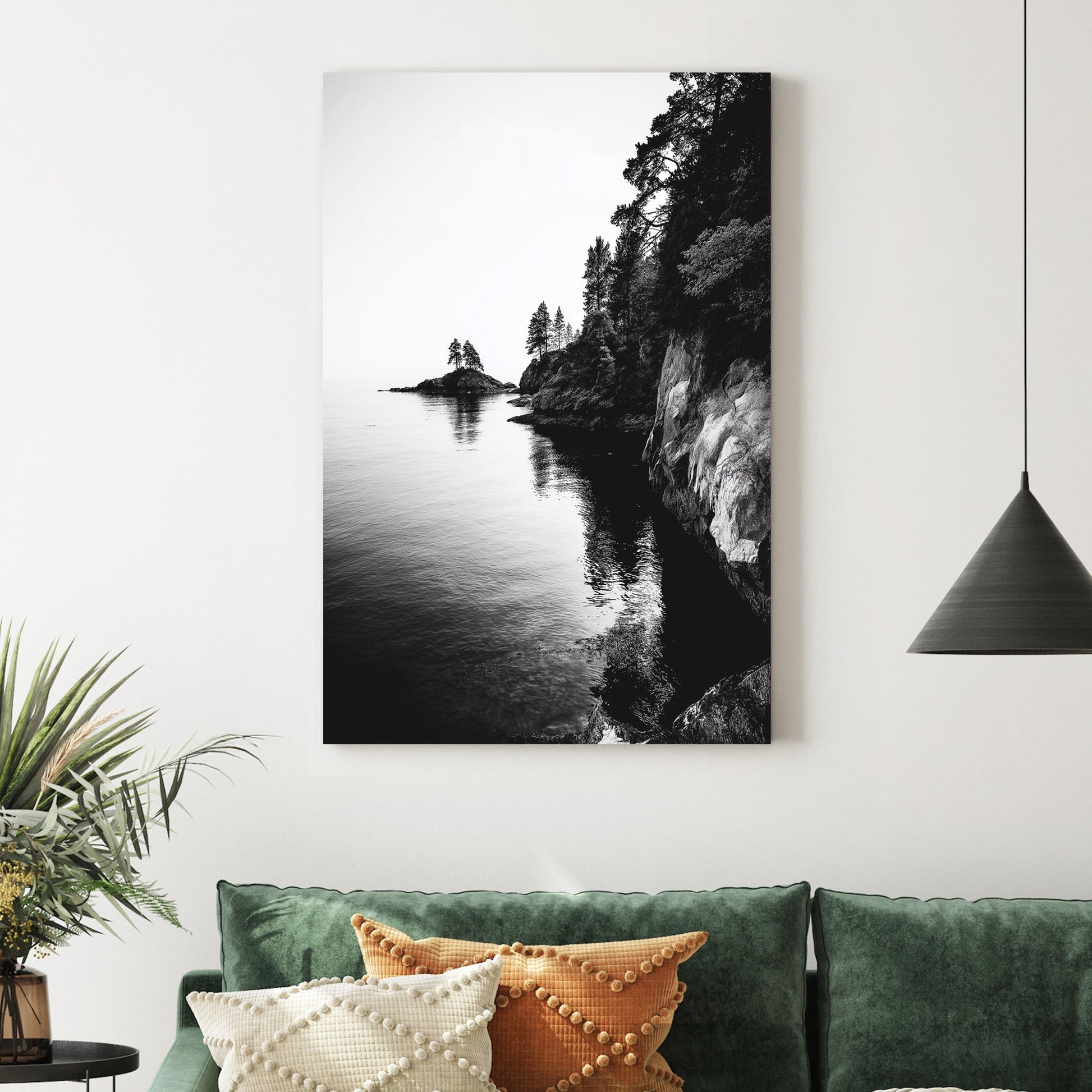 black and white rocky coastline with trees and ocean reflections