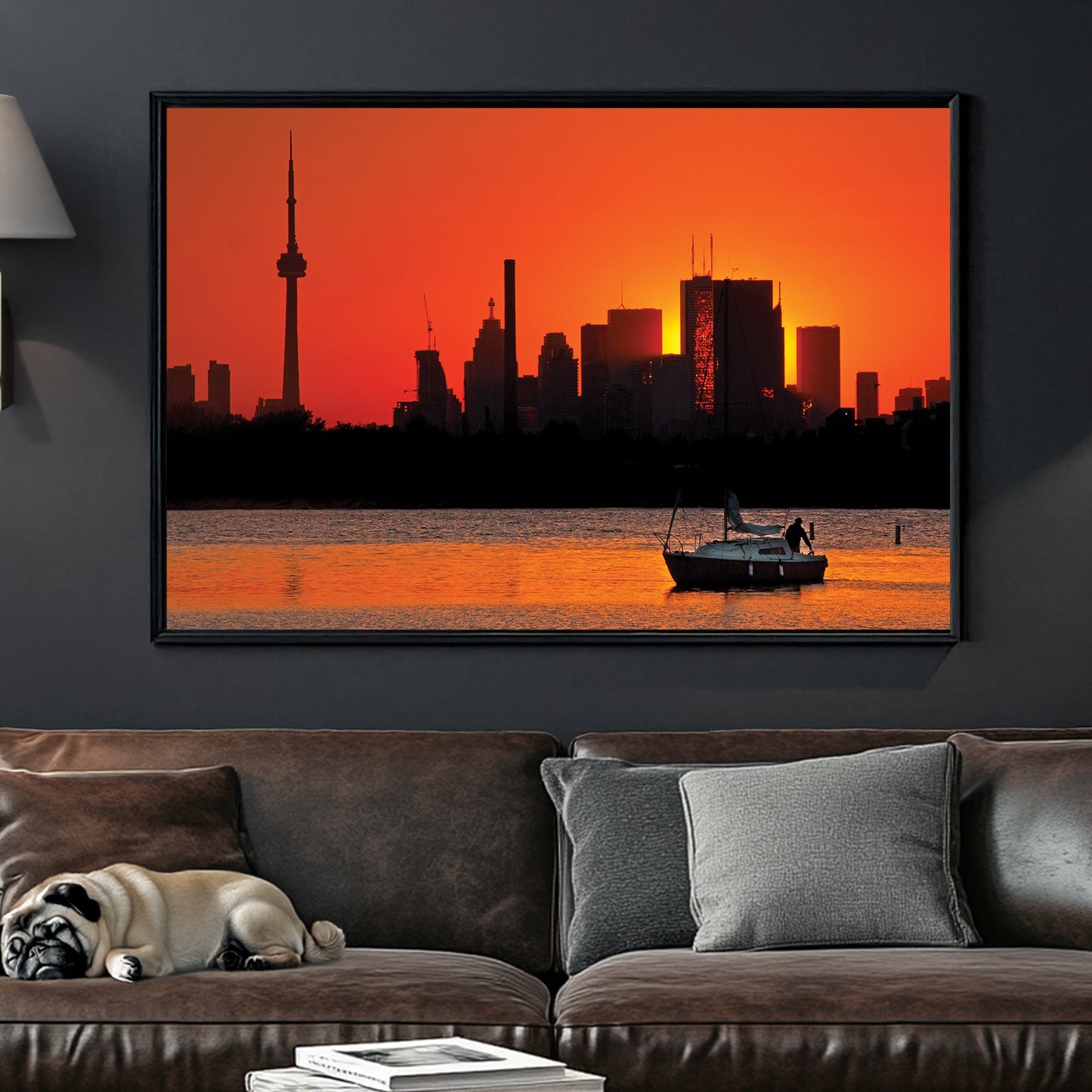 Toronto skyline at sunset with sailboat on water at Ashbridges Bay