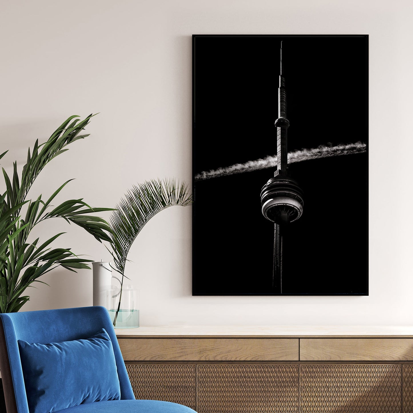 Black and white CN Tower photo with jet trail crossing sky