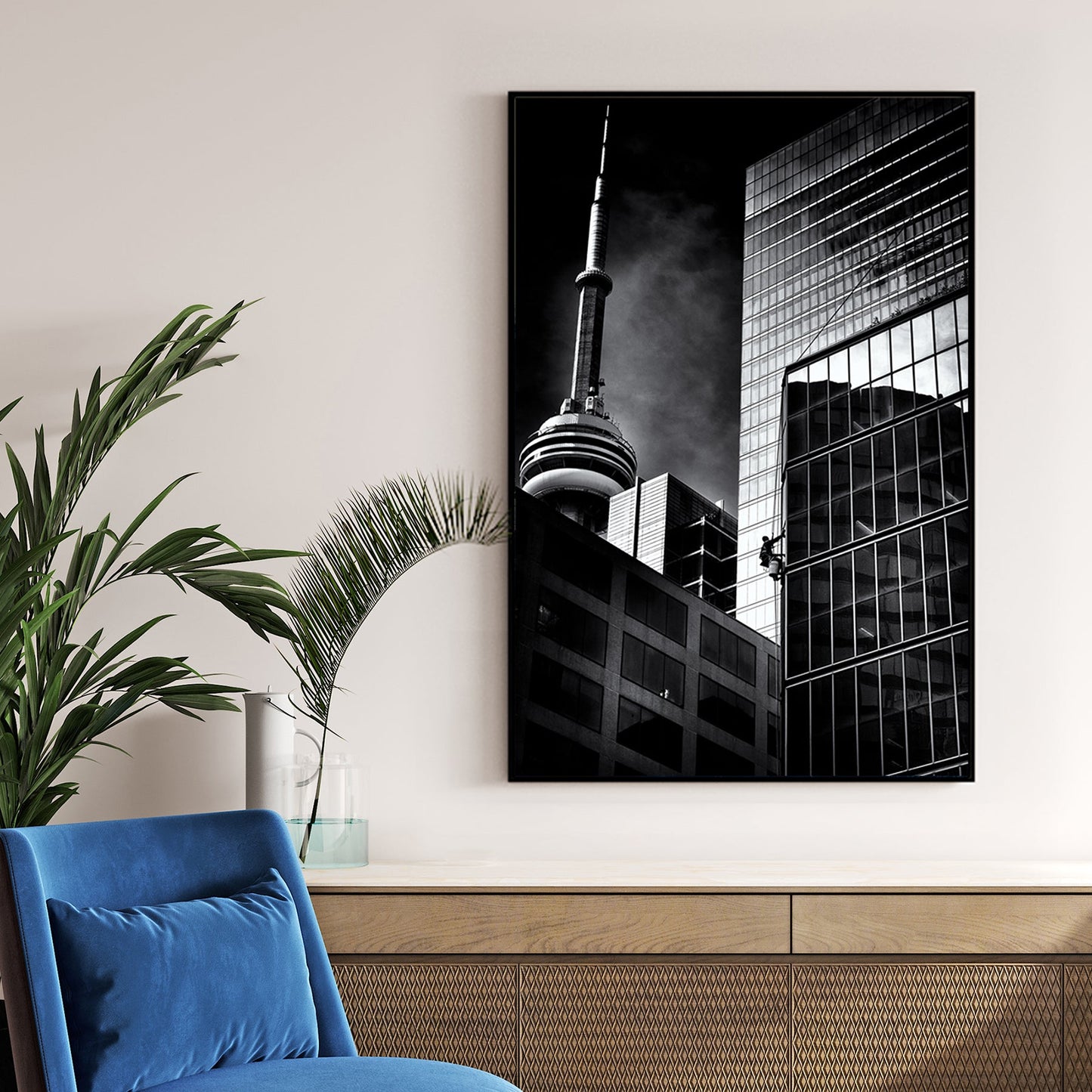 black and white photo of CN Tower and window washer on Toronto skyscraper