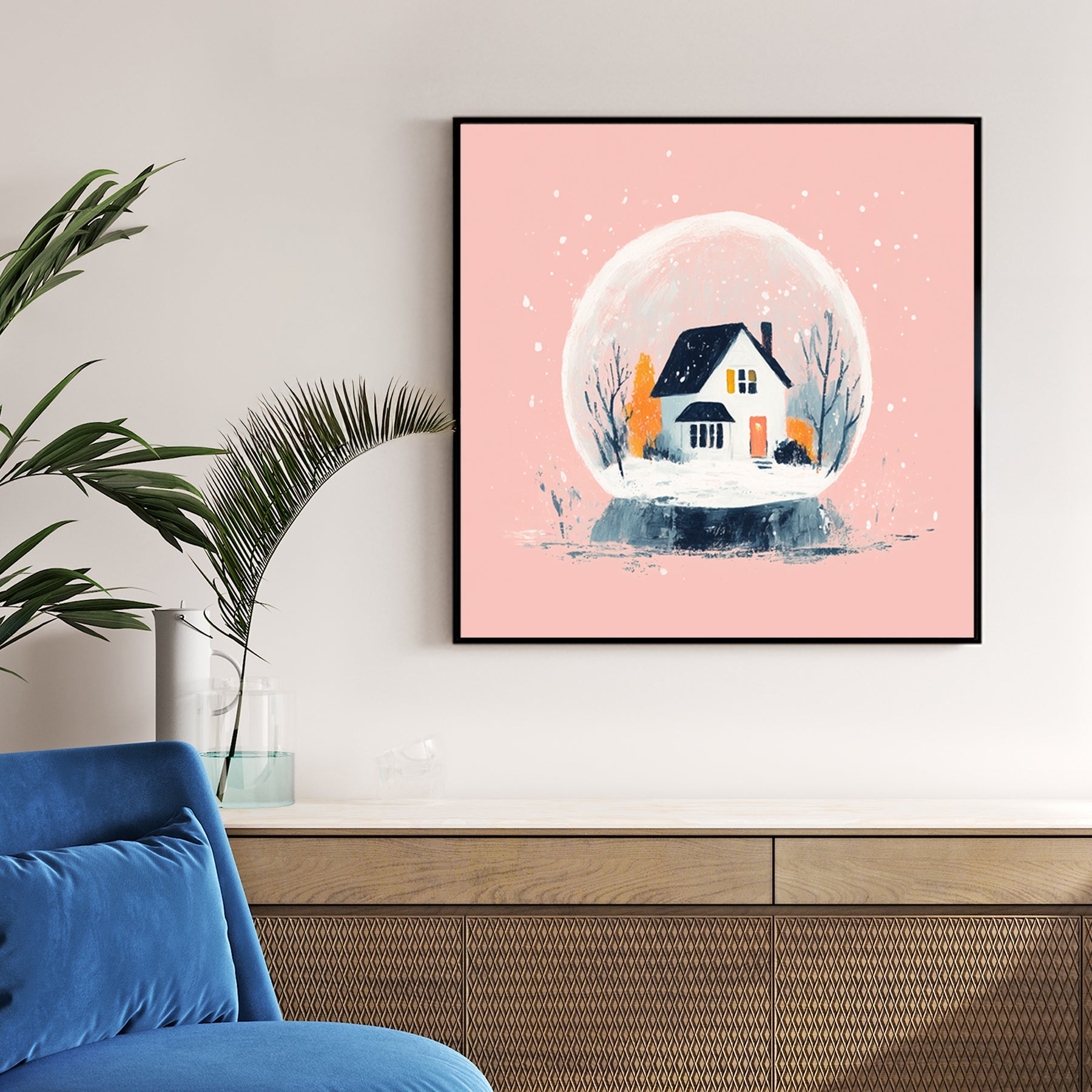 modern snow globe wall art with winter cottage on pink background
