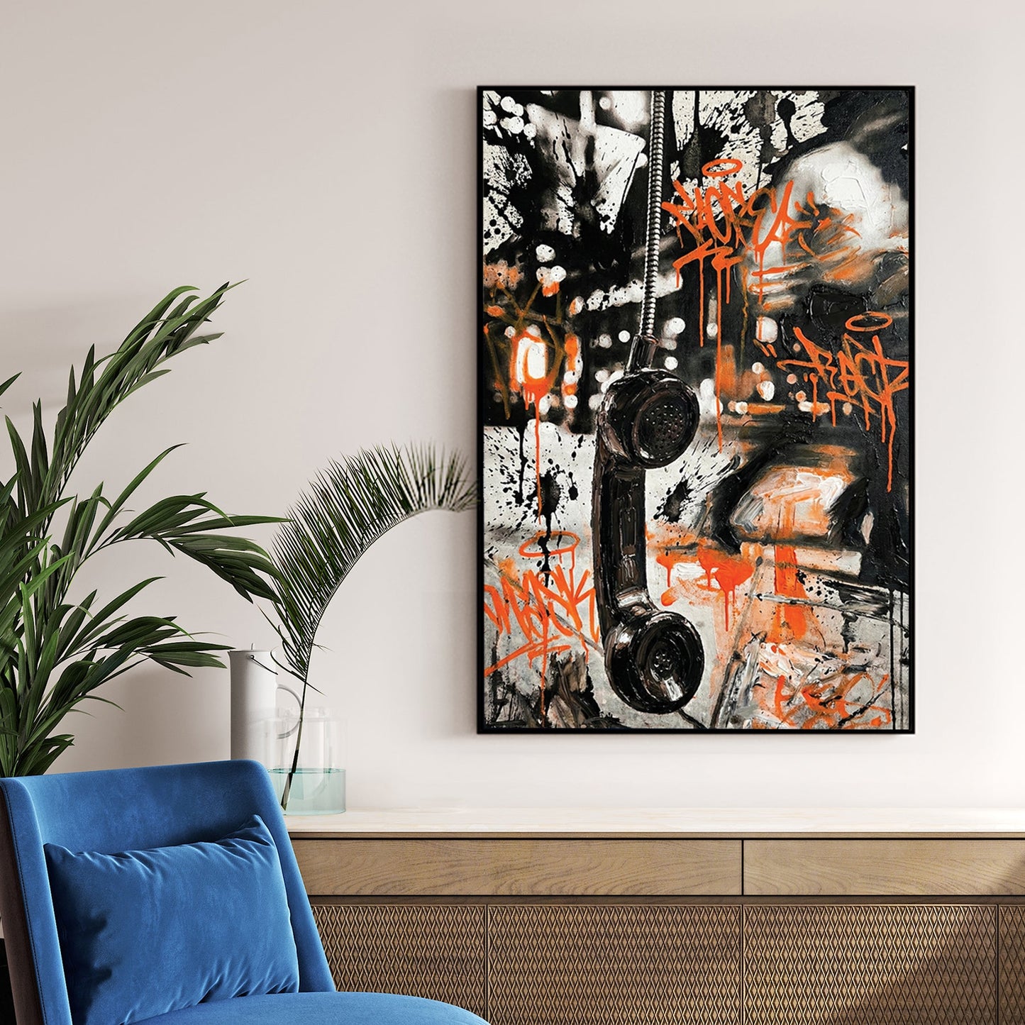 Vintage telephone handset wall art with orange graffiti tags and black marks.