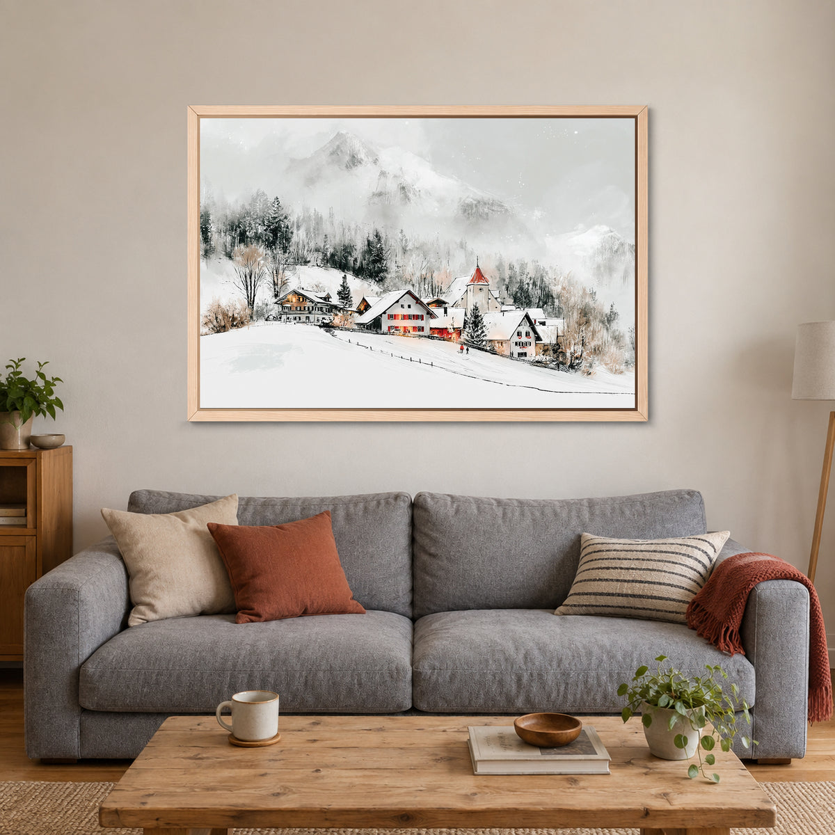 Swiss Alps Winter Chalets framed canvas in a natural wood floating frame above a grey sofa with rust and striped cushions