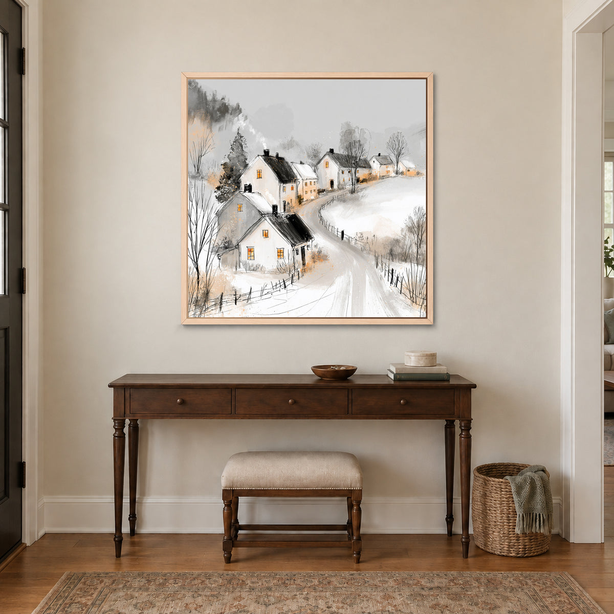 The Lane Home in Winter framed canvas in a natural wood floating frame above a dark wood console table and upholstered bench