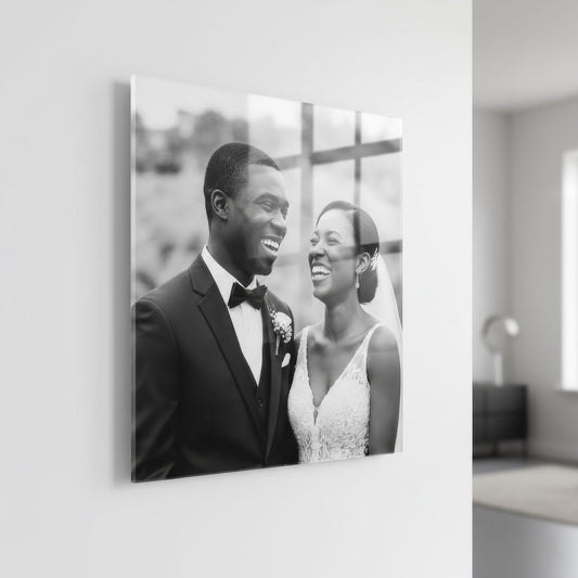 Black and white acrylic photo print of a bride and groom on a wall in a modern interior setting.