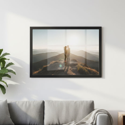 Black frame photo print of a couple on a mountain top