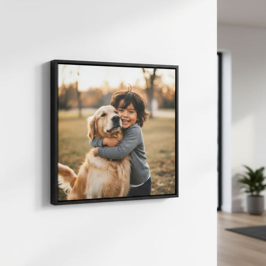 Black framed canvas photo of a child hugging a dog on a wall in a room.