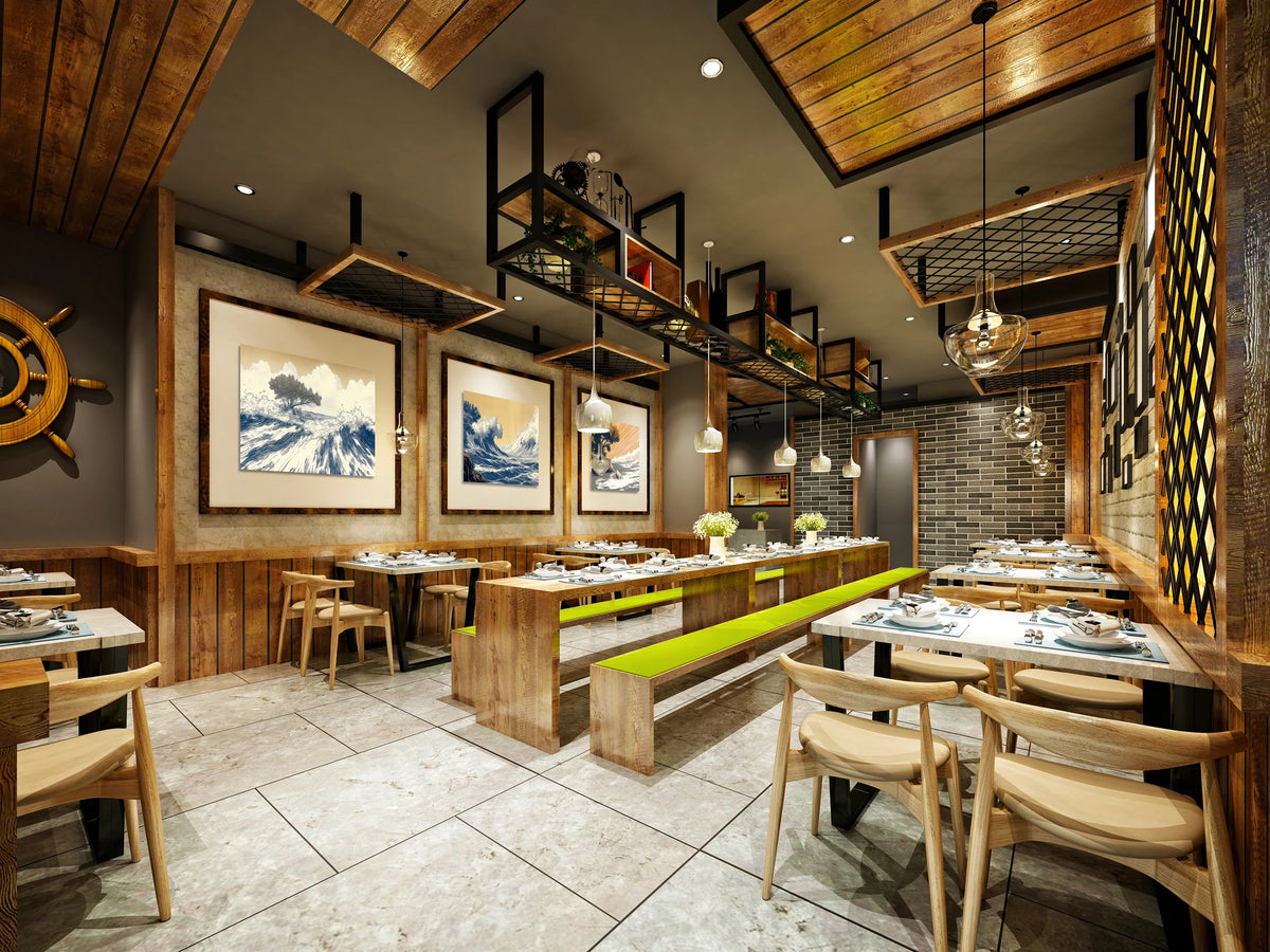A modern restaurant interior with wooden ceiling panels, hanging pendant lights, framed ocean-wave wall art, and dining tables with light wood chairs and bright green bench accents.