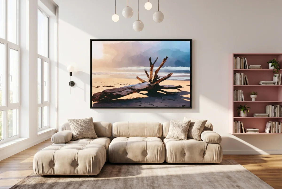 Beige sectional sofa in a living room with a large framed picture of driftwood on a beach.
