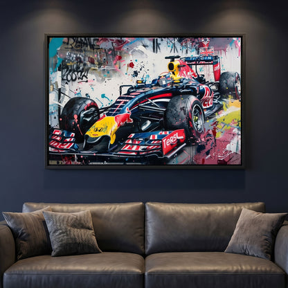 Framed canvas print of a Red Bull F1 car on a dark wall above a sofa.