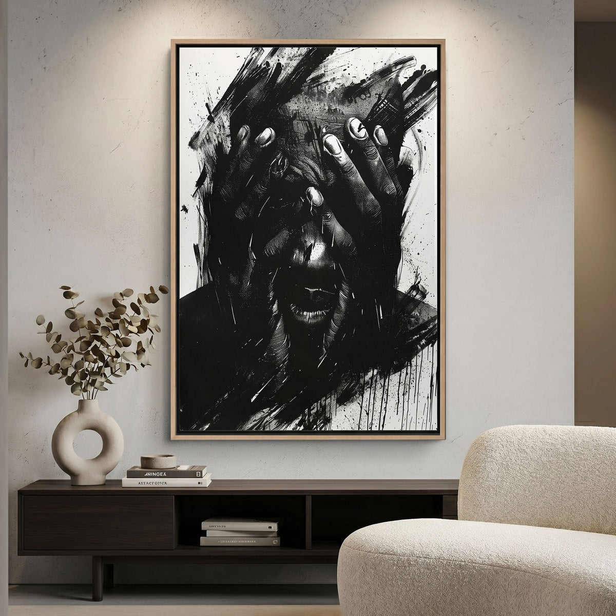 Abstract black and white canvas print on a wall above a wooden cabinet with decorative items.