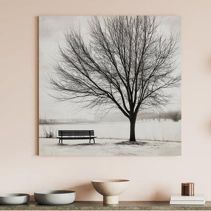 Lone tree with a bench in a snowy landscape, minimalist winter artwork.