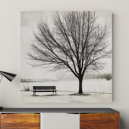 Lone tree with a bench in a snowy landscape, minimalist winter artwork.