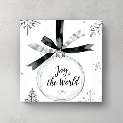 Black-and-white illustration of a holiday ornament with the phrase “Joy to the World” and surrounding snowflakes.