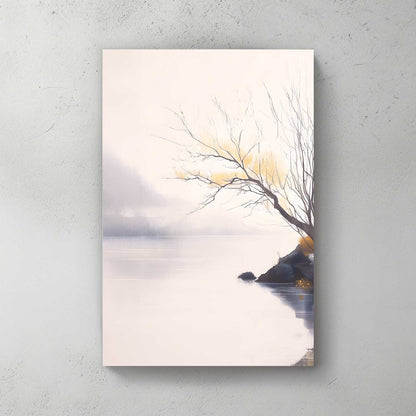 Canvas print of a tree by a lake with a sunset, on a light gray wall.