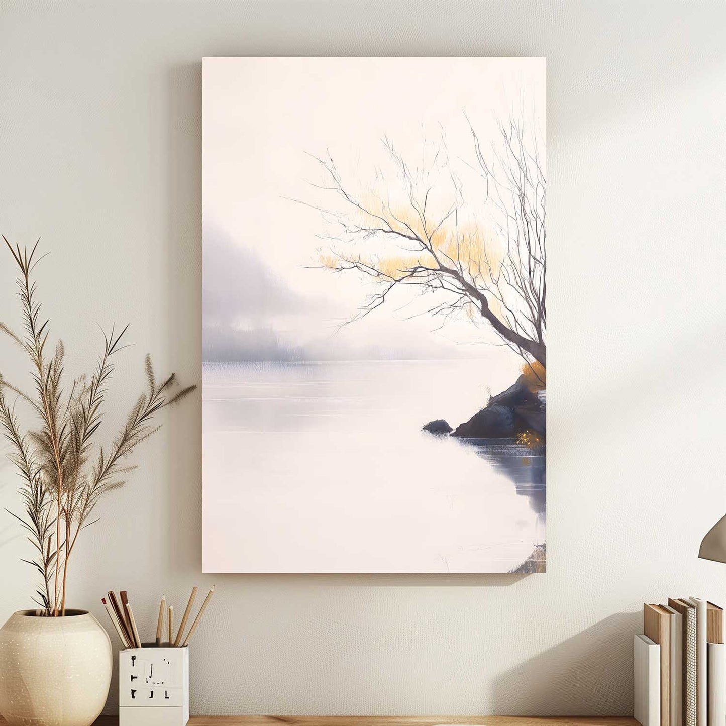 Canvas print of a tree by a lake on a wall with decor items below.