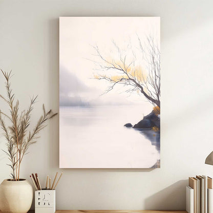 Canvas print of a tree by a lake on a wall with decor items below.
