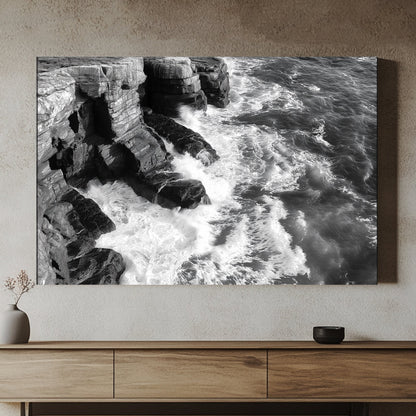 A black-and-white portrayal of rugged cliffs against the relentless ocean waves. Perfect for modern decor. canvas wall art abstract portrait landscape