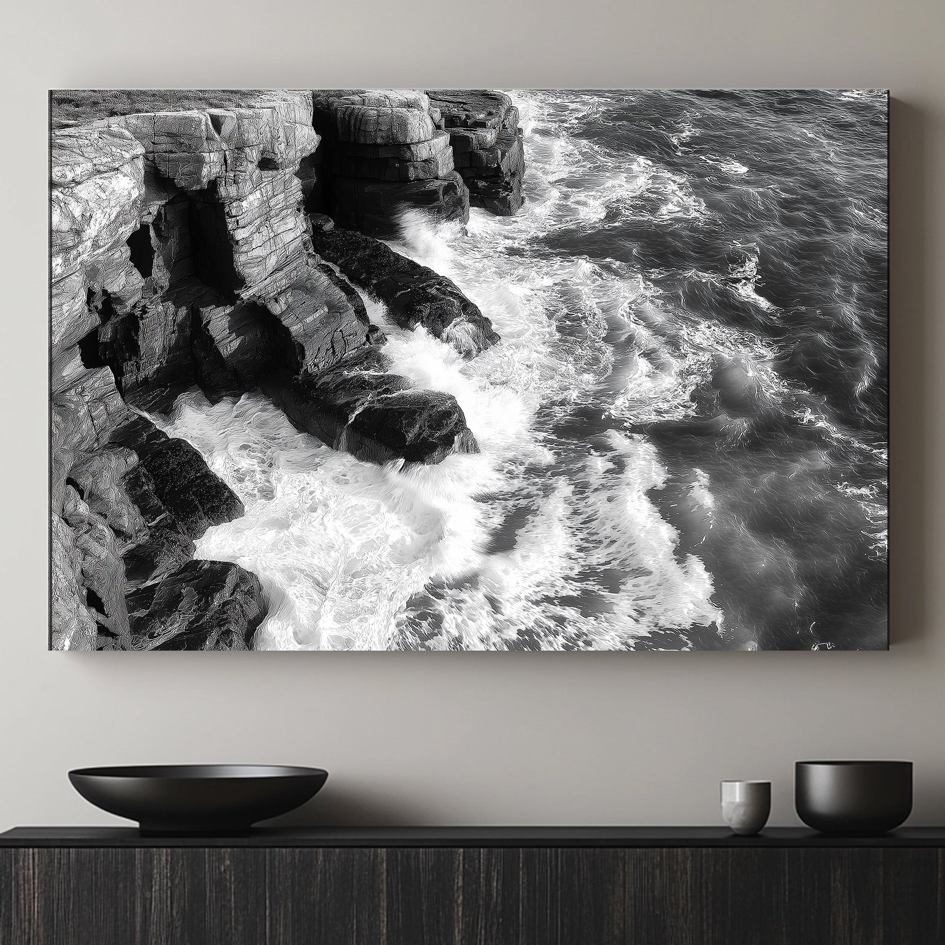 A black-and-white portrayal of rugged cliffs against the relentless ocean waves. Perfect for modern decor. canvas wall art abstract portrait landscape