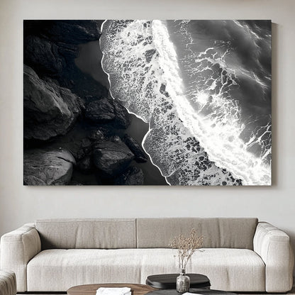 This striking black-and-white photograph captures the powerful contrast between rugged rocks and the ocean. Perfect for modern decor. canvas wall art abstract portrait landscape