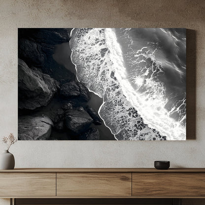 This striking black-and-white photograph captures the powerful contrast between rugged rocks and the ocean. Perfect for modern decor. canvas wall art abstract portrait landscape