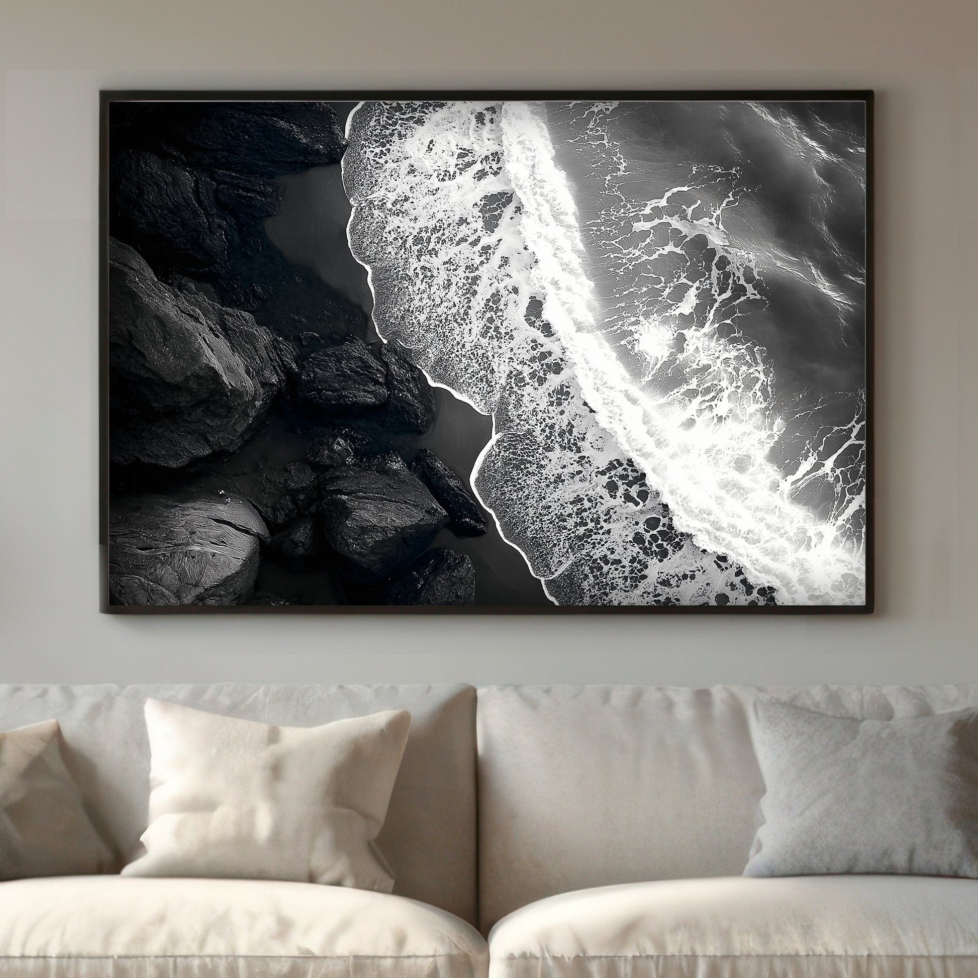 This striking black-and-white photograph captures the powerful contrast between rugged rocks and the ocean. Perfect for modern decor. canvas wall art abstract portrait landscape