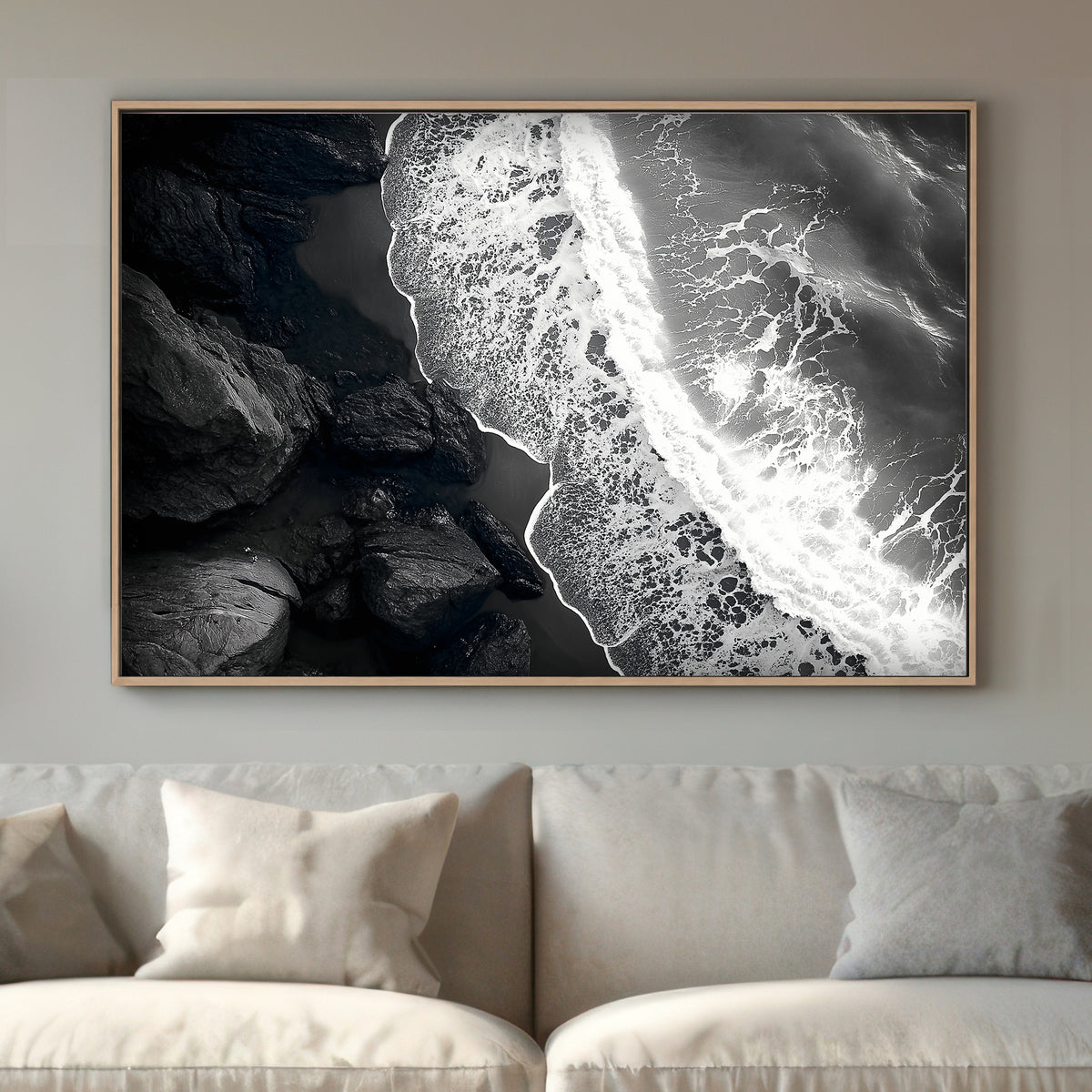 This striking black-and-white photograph captures the powerful contrast between rugged rocks and the ocean. Perfect for modern decor. canvas wall art abstract portrait landscape