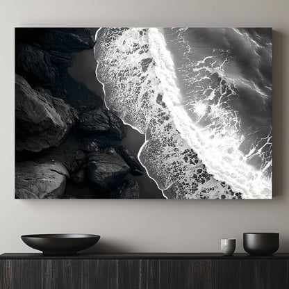 This striking black-and-white photograph captures the powerful contrast between rugged rocks and the ocean. Perfect for modern decor. canvas wall art abstract portrait landscape