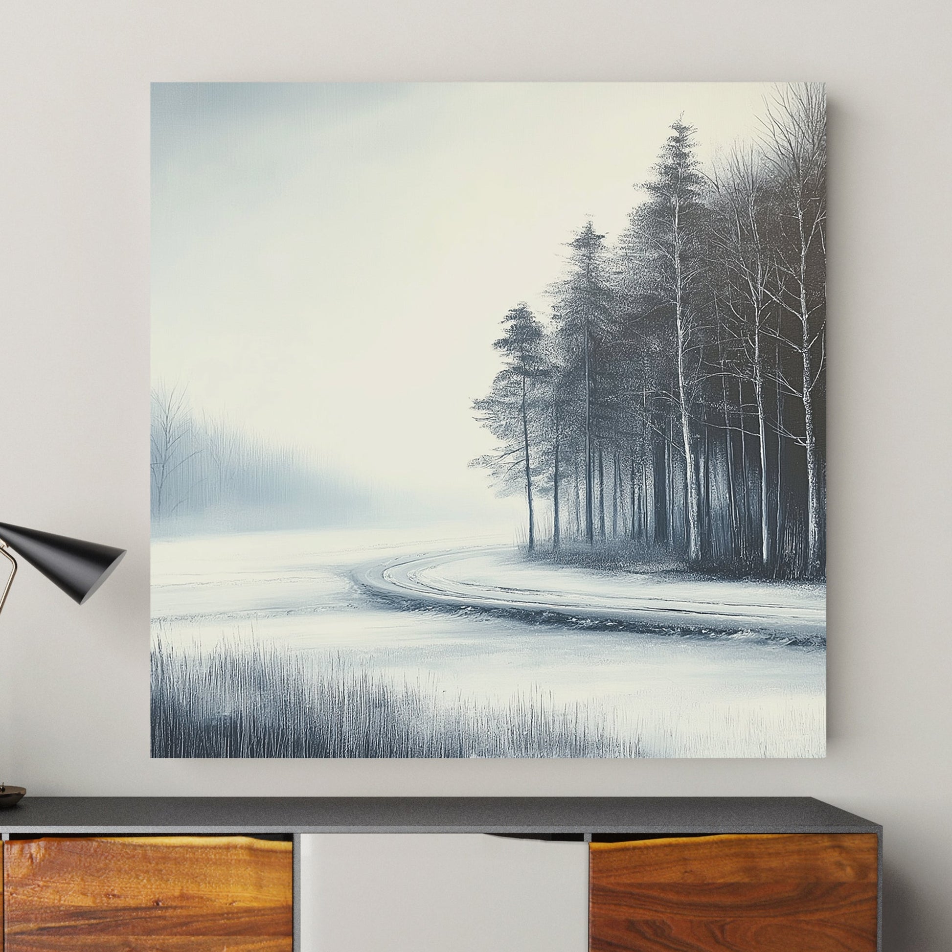 Frosted winter path winding through a snowy forest with bare trees and a misty atmosphere.