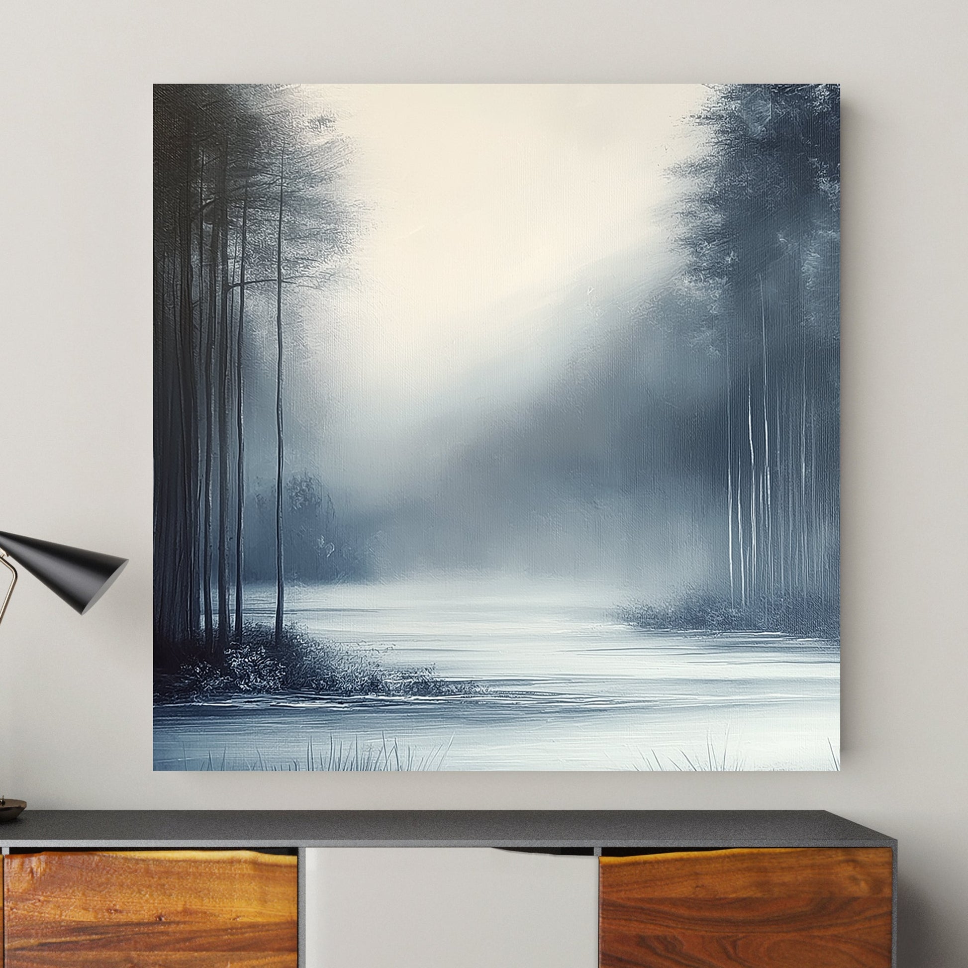 Misty winter landscape with slender trees and a serene frozen water surface enveloped in soft fog.