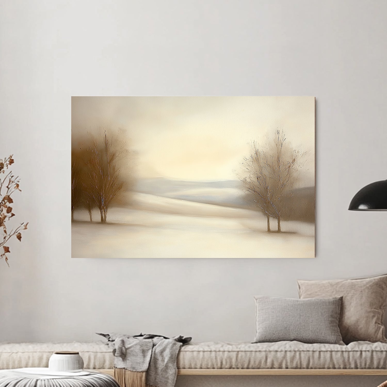 Serene snowy landscape with soft beige tones and bare trees under a pale winter sky.