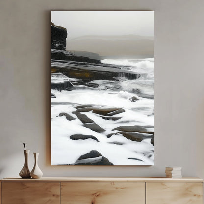 Impressionist artwork of waves flowing over rugged coastal cliffs under a misty, overcast sky.