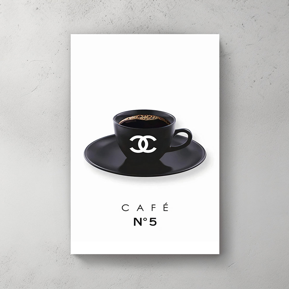 A minimalist art print of a branded black coffee cup with the Chanel logo, placed on a matching saucer, against a clean white background.