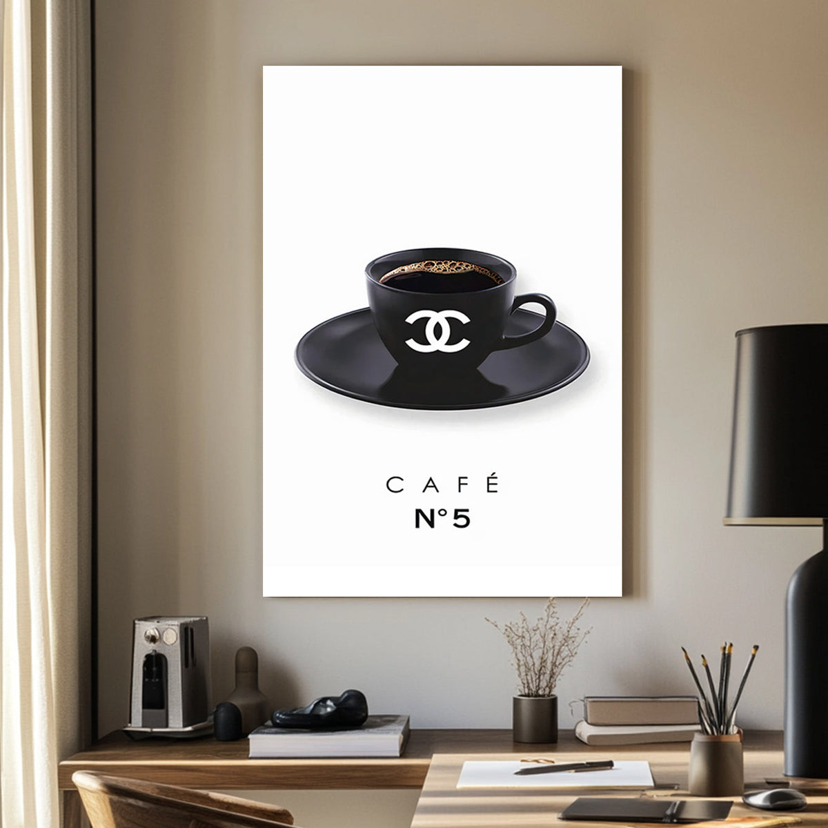 A minimalist art print of a branded black coffee cup with the Chanel logo, placed on a matching saucer, against a clean white background.