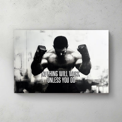 A black-and-white wall art print of a muscular boxer with clenched fists, accompanied by the motivational text "Nothing Will Work Unless You Do."