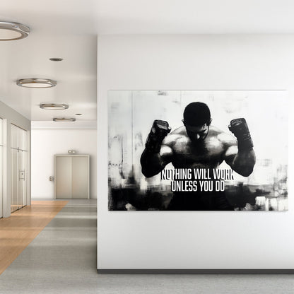 A black-and-white wall art print of a muscular boxer with clenched fists, accompanied by the motivational text "Nothing Will Work Unless You Do."